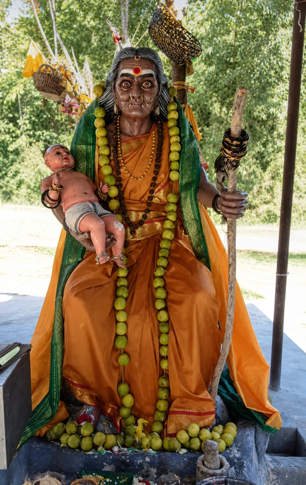 Outdoor reference statue of Periyachi Amman holding a baby